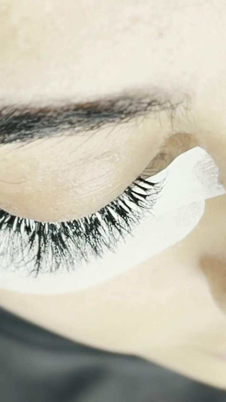 A lash set in progress, eye pads on